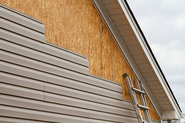 Professional Storm Damage Siding Repair technician working in Vermilion, OH